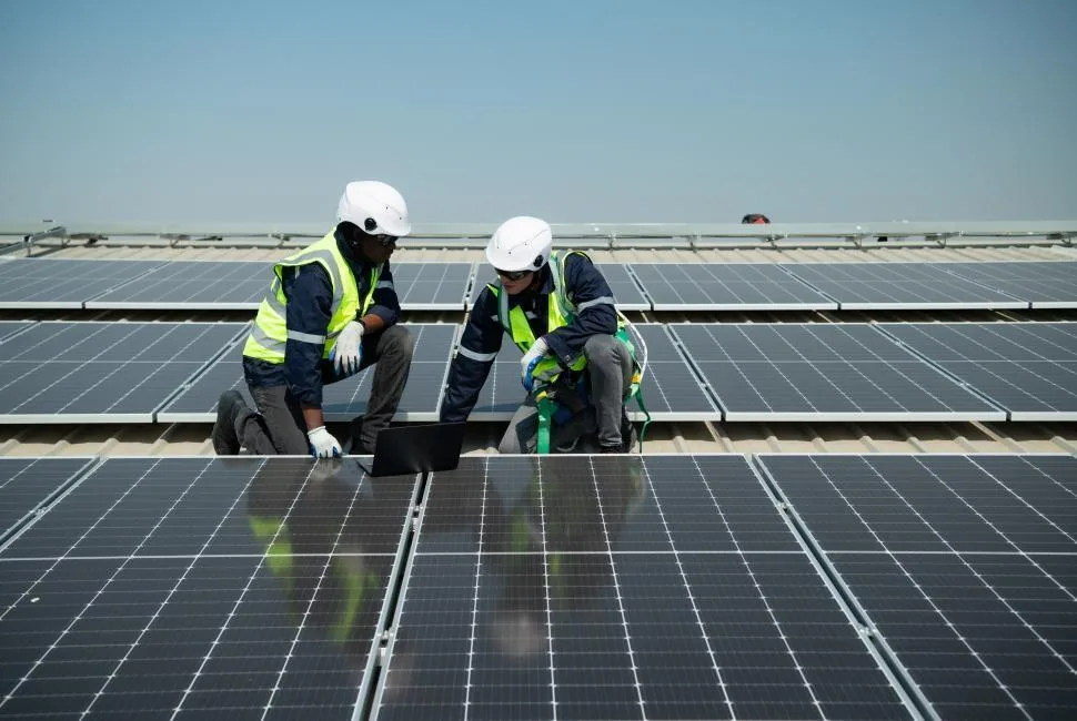 Solar installers working together on a rooftop installation